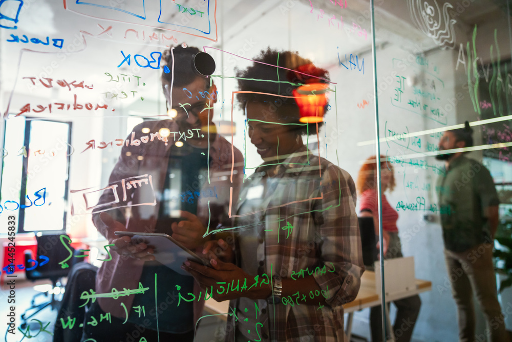 Group of business people and software developers working as a team in modern startup office