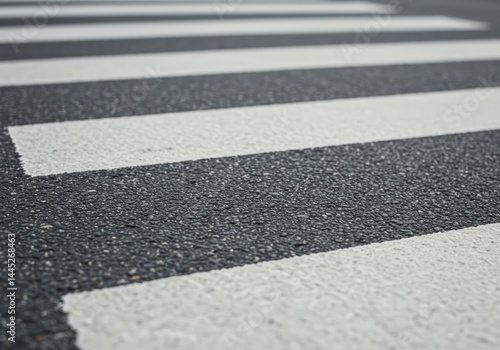 Obraz na płótnie Close up view of a pedestrian crossing on asphalt road. White lines on black pavement. Safety sign for walking across street for traffic and urban planning. w salonie