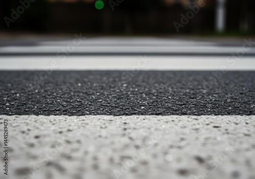 Obraz na płótnie Close up view on a fresh pedestrian crosswalk marking on wet asphalt road providing clear visibility for road safety concept education and awareness campaigns. w salonie