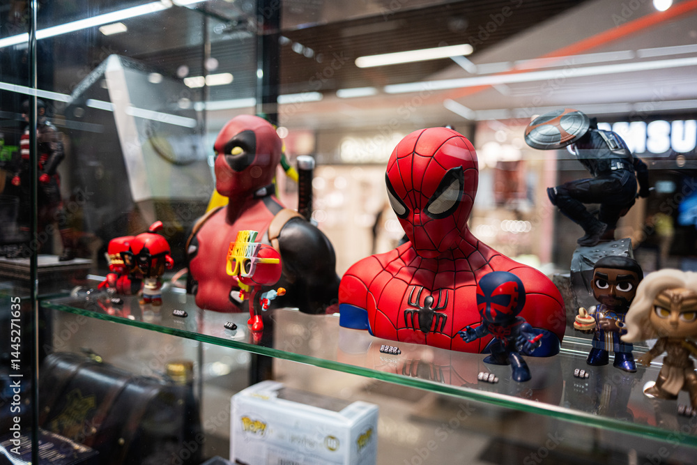 Naklejka premium Superhero collectible figurines displayed in a retail store cabinet showcasing vivid colors