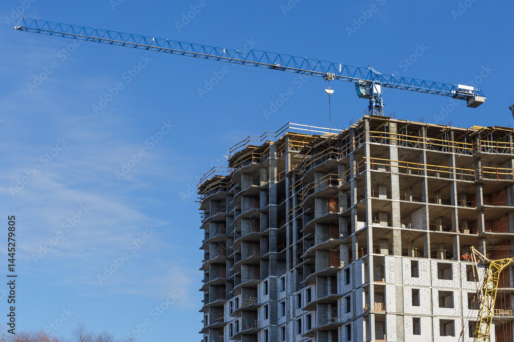 Extensive scaffolding providing platforms for work in progress on a new apartment block,Tall building under construction with scaffolds,Construction Site of New Building Extensive scaffolding providing platforms for work in progress on a new apartment block,Tall building under construction with scaffolds,Construction Site of New Building