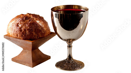 A silver chalice filled with red liquid sits next to a loaf of bread.