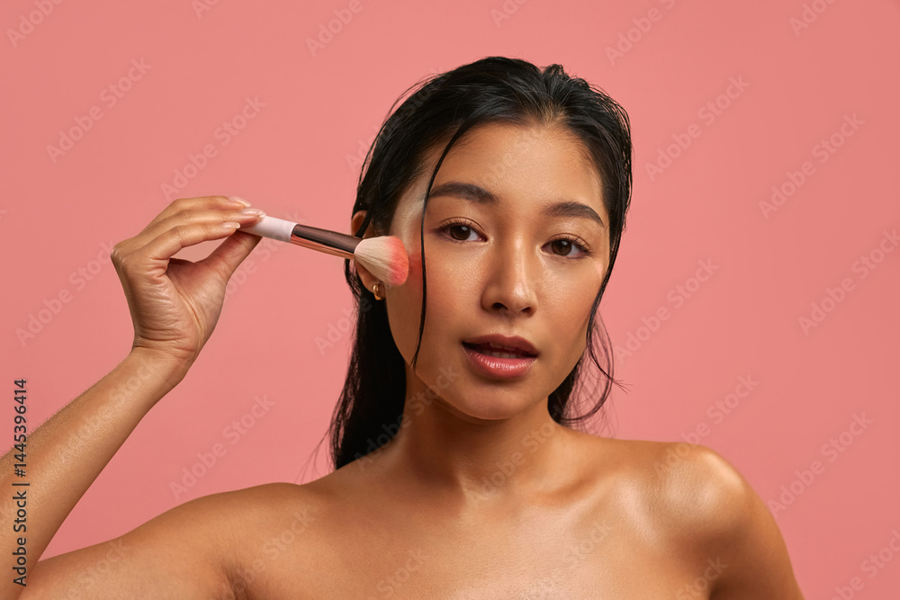 Fototapeta premium Young Asian woman on pastel pink background.