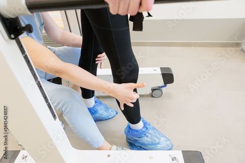 Therapist assisting patient during supported walking exercise in a rehabilitation clinic