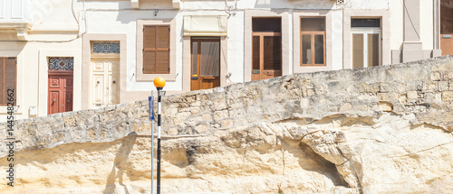 Obraz na płótnie Wide image showing multiple entrance doors and windows of a residential building in Malta w salonie