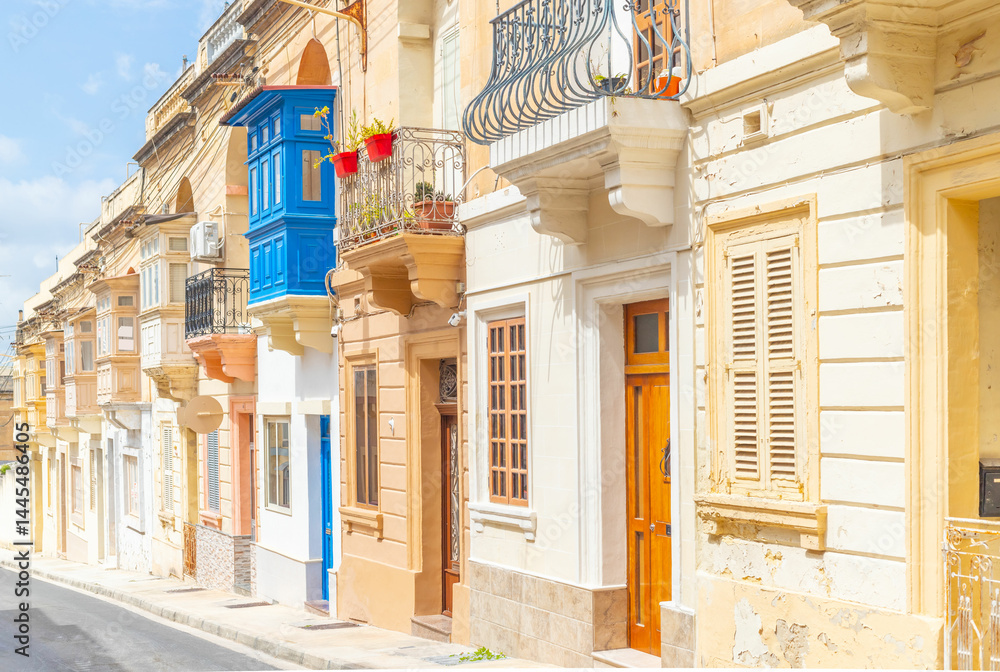 Typical Maltese street with old residential buildings in traditional architectural style, Malta