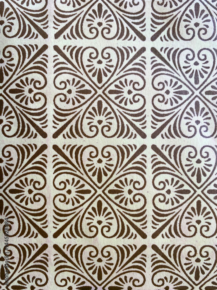 Delicate gold block printing brings intricate geometric floral motifs to life on pristine white paper, blending opulence with fine craftsmanship. Delicate gold block printing brings intricate geometric floral motifs to life on pristine white paper, blending opulence with fine craftsmanship.