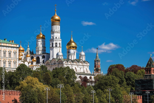 Moscow on a sunny day. The Grand Kremlin Palace, the Annunciation Cathedral, the Archangel Cathedral and the bell tower of Ivan the Great on the Kremlin embankment. The business card of Moscow.
