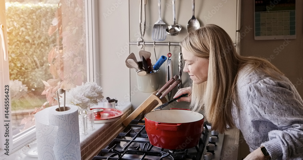 Woman, smell and cooking at stove pot or warm winter meal, stew dinner or smile in kitchen. Female person, gas appliance or prepare nutrition eating as soup diet or fresh taste, hungry health in home