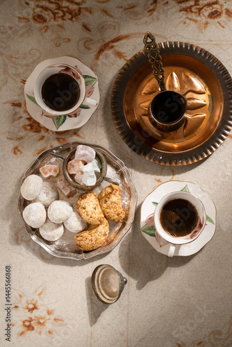Turkish coffee with traditional sweets on antique carpet
