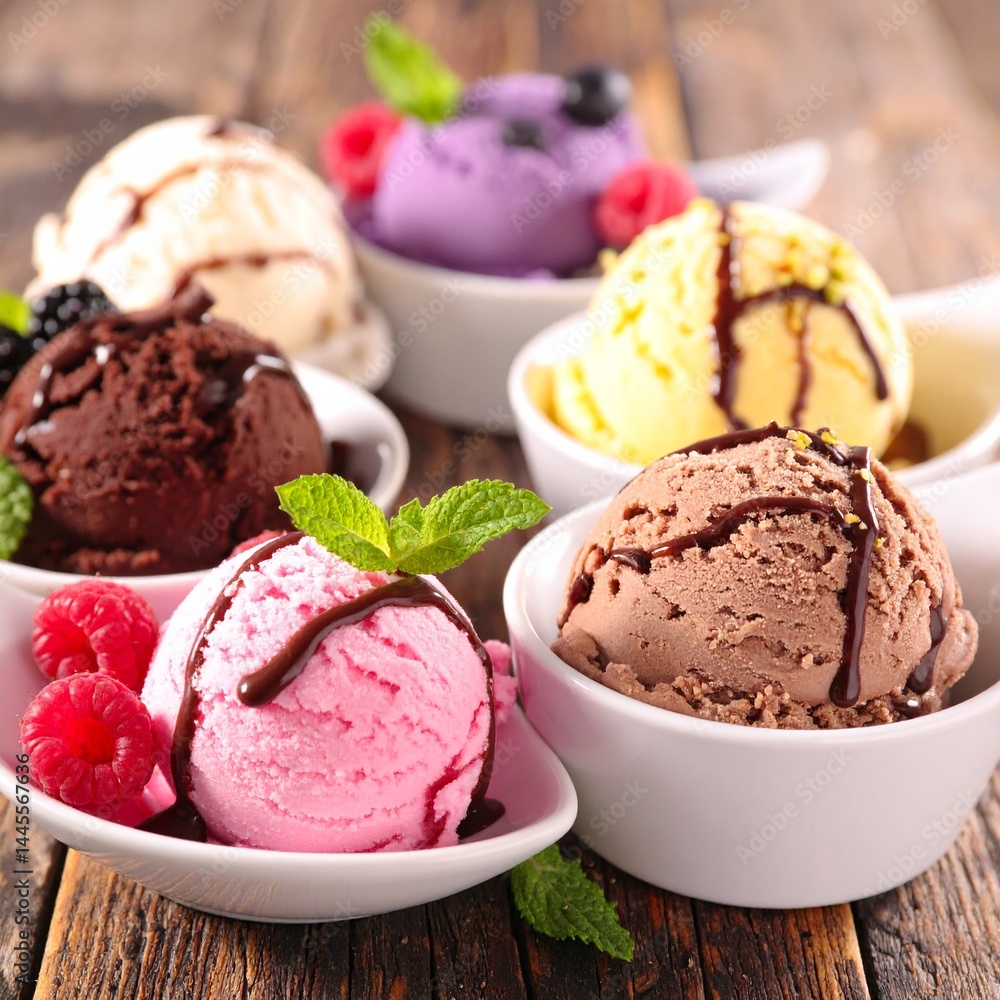 A selection of homemade ice creams: creamy vanilla, pistachio, black raspberry, chocolate chip, and chocolate, drizzled with chocolate sauce, topped with mint, berries, and chocolate shavings. A selection of homemade ice creams: creamy vanilla, pistachio, black raspberry, chocolate chip, and chocolate, drizzled with chocolate sauce, topped with mint, berries, and chocolate shavings.
