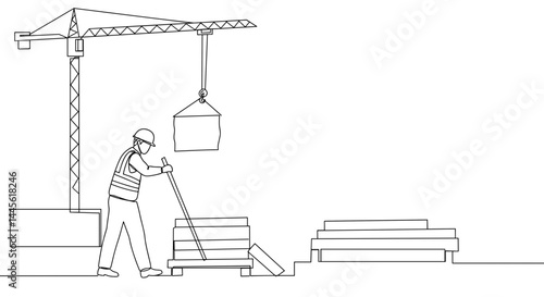 Construction worker operating crane with materials in a site  
