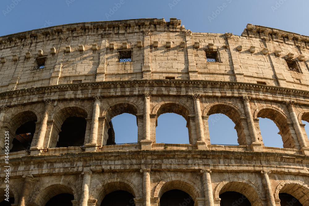 Obraz premium The Roman Colosseum ancient amphitheatre ruin in the center of Rome, Italy.