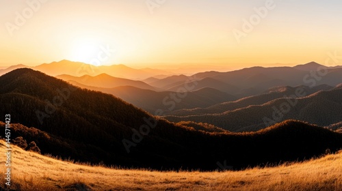 Obraz na płótnie The golden hour sunlight illuminates rolling mountains and grassy fields w salonie