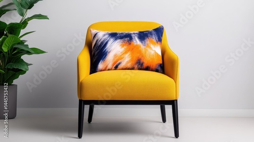 Mustard yellow armchair with vibrant tie-dye pillow