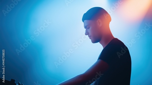 Obraz na płótnie Music DJ performing on stage during live electronic music concert at night. w salonie