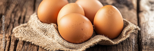 Obraz na płótnie Brown eggs nestled in burlap on rustic wood surface Generative AI w salonie