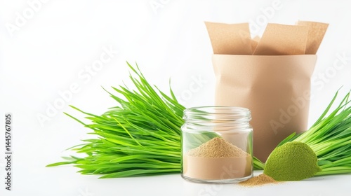 A clean, minimalistic image of a small glass jar filled with wheatgrass powder, surrounded by fresh wheatgrass plants.