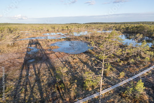 Estonia - April 26 2025: Aerial View of Konnu Suursoo Raised Bog from observation tower. Spring Morning. Wooden Duckboards Over Floating Peat Moss, Deep Hollows, and the Wetland Landscape.