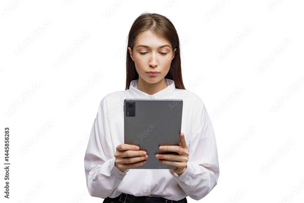Engaging young woman studies intently on a tablet device in a minimalistic white setting Engaging young woman studies intently on a tablet device in a minimalistic white setting