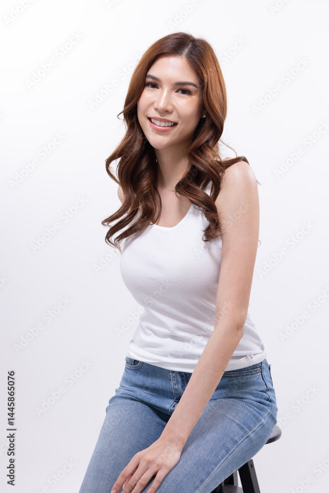 Smiling woman sitting on stool in casual outfit Smiling woman sitting on stool in casual outfit