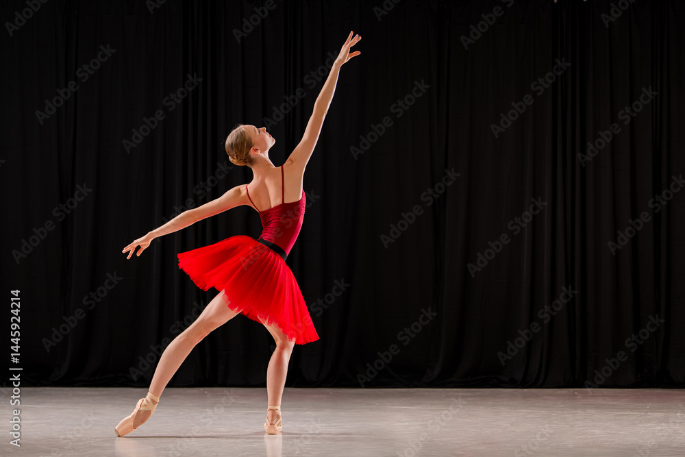 ballerina in a vibrant red dress performs a variation on stage. Capturing the grace and skill of ballet in a dynamic pose. ballerina in a vibrant red dress performs a variation on stage. Capturing the grace and skill of ballet in a dynamic pose.