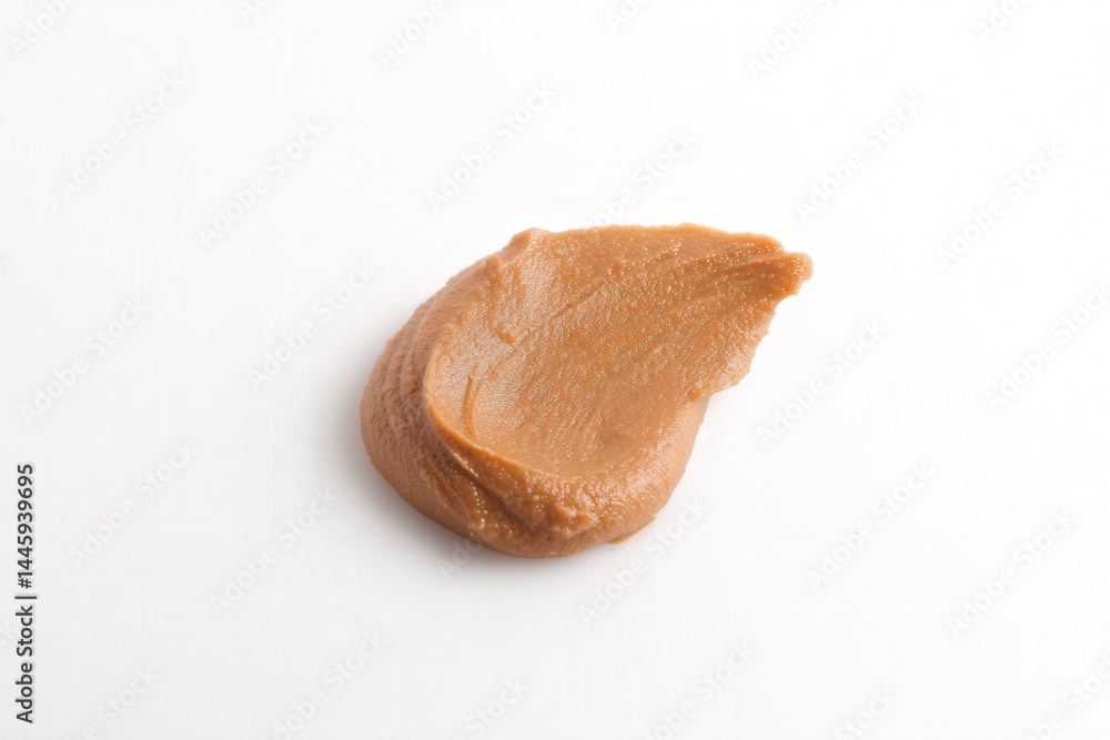 Spoonful swirl of smooth peanut butter on white background
Spoonful swirl of smooth peanut butter on white background
