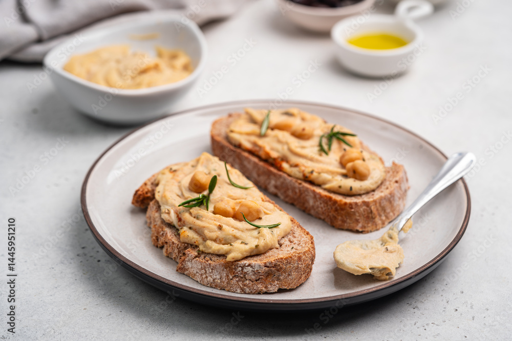 Delicious sandwiches with hummus and ingredients on white table, flat lay. High quality photo