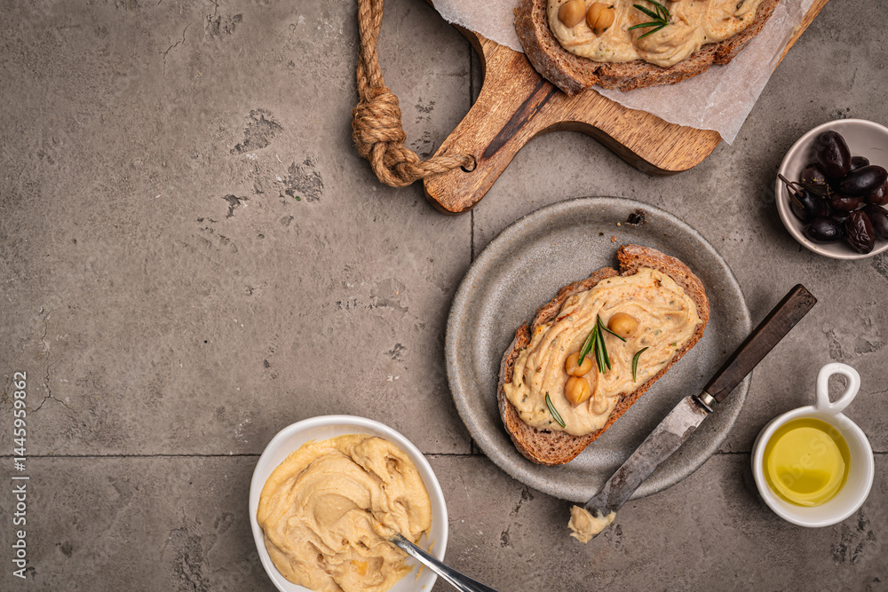 Delicious sandwiches with hummus and ingredients on a dark background, top view, flat lay. High quality photo