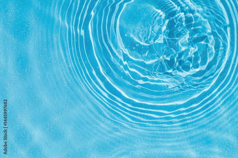 drops on water with circles on a blue background