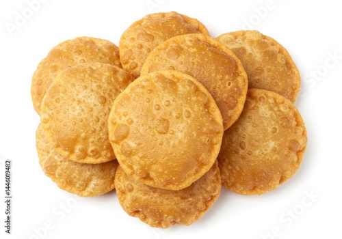 Stack of golden brown puri bread on a white background, a popular indian food