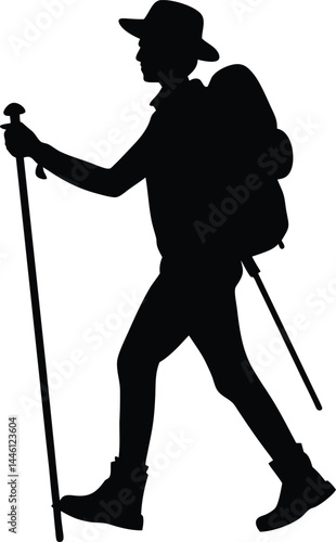 silhouette of a hiker with backpack and stick 