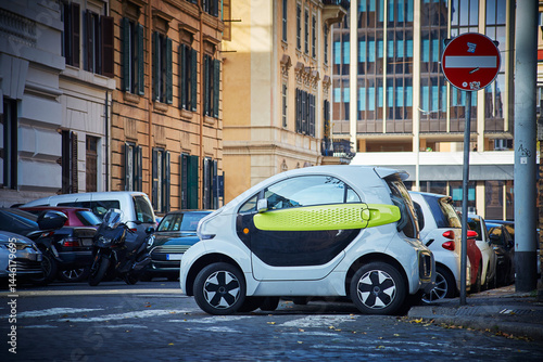Small mini electric compact car parked on the street