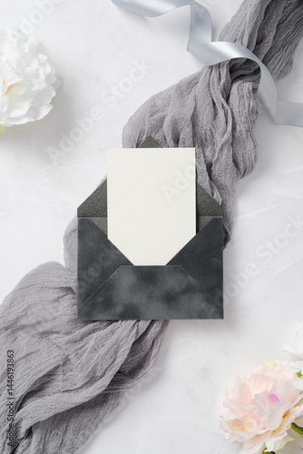 Elegant wedding stationery set on textured fabric background