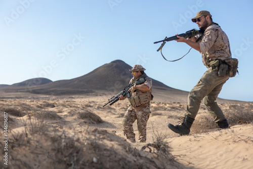 Military soldiers patrol desert landscape with rifles