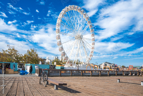 The famous ferris wheel at Bay area, San Francisco. Visitors or tourists take a ride to enjoy spectacular view of the Alcatraz island and the Oakland bridge over the San Francisco bay. 