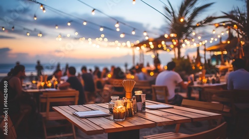 Outdoor dining area on a beach at twilight.
