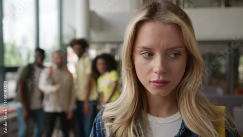 Caucasian girl suffering with lonely stressed woman girl student grief in university high school college bullying by multiracial students diversity classmates bully mock up education problem mockery