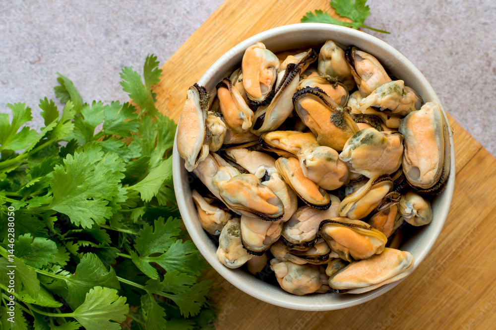 Cleaned boiled mussels in a bowl on a dark background, horizontal Cleaned boiled mussels in a bowl on a dark background, horizontal