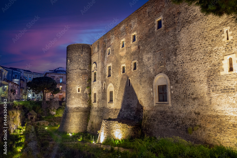 Ursino Castle and Moat in Catania, Sicily, Italy, artificially illuminated at night Ursino Castle and Moat in Catania, Sicily, Italy, artificially illuminated at night