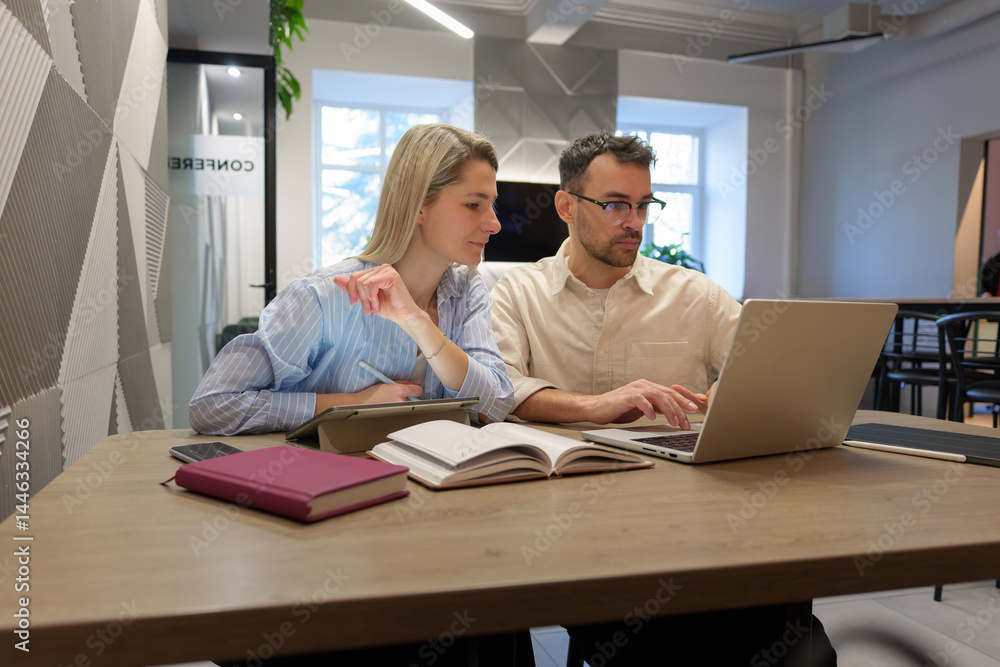 Professional teamwork displayed as coworkers collaborate on a project in a bright office Professional teamwork displayed as coworkers collaborate on a project in a bright office