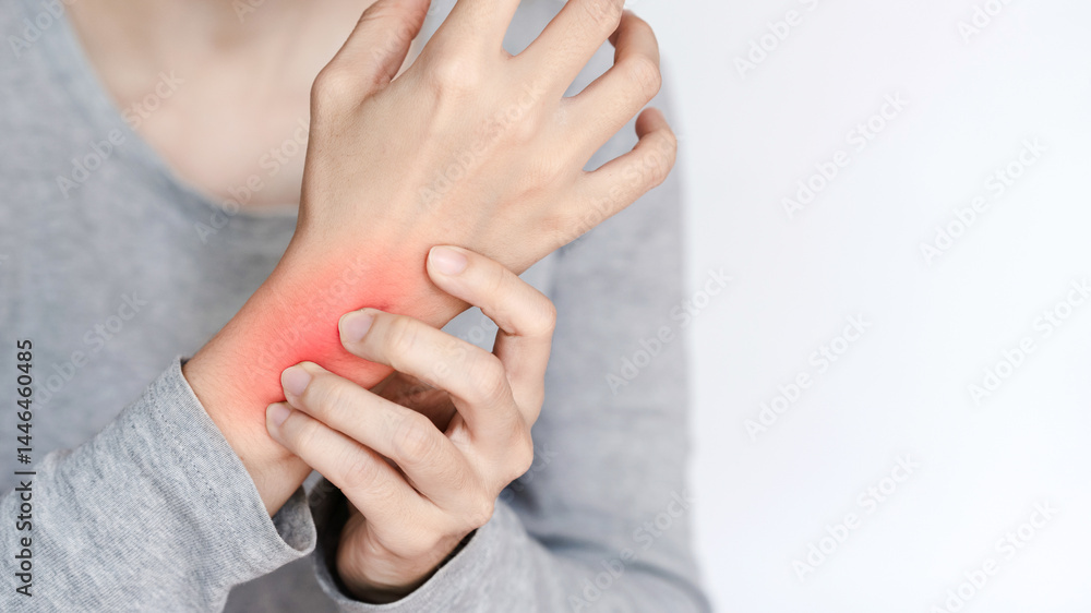 Fototapeta premium Wrist pain concept showing chronic discomfort and therapy need with person holding their inflamed wrist in pain