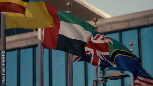 International flags waving in the wind in front of the United Nations headquarters in New York City