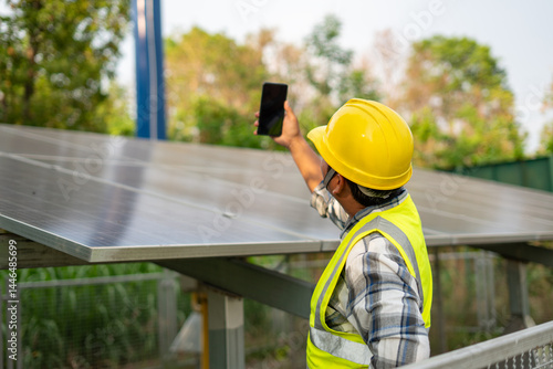 Solar Panel Technician Inspection: A diligent technician inspects a solar panel array using a smartphone, showcasing meticulous attention to detail and commitment to renewable energy.