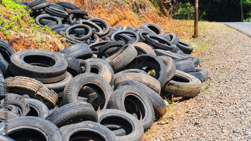 Used tire waste scattered on the side of the road in rural areas spoils the view and pollutes the environment.