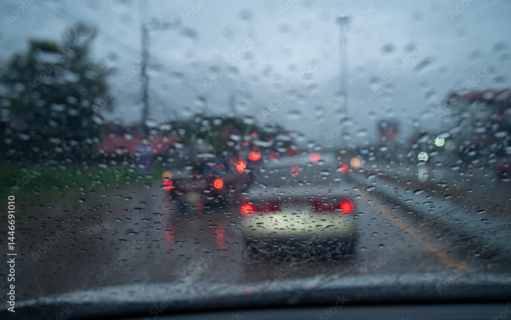 Rain drop on the car glass window while driving on the road.