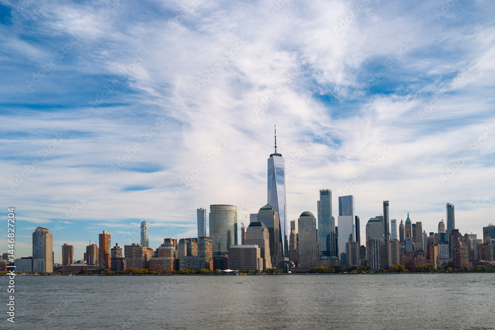 Obraz premium New York City cloudy skyline. NYC skyscrapers. Manhattan. NY cityscape with clouds. Downtown New York buildings. NYC skyline on clouds. New York harbor view. Skyscrapers in Manhattan. NYC downtown.