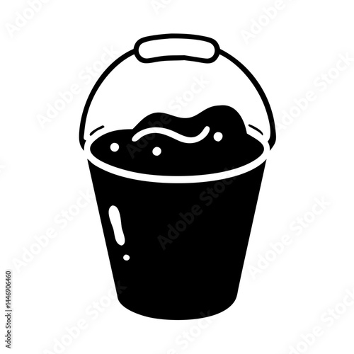 A black and white illustration of a bucket filled with liquid