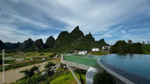 Canvas Print Infinity pool at luxury resort overlooking dramatic karst mountains of Yangshuo (Guilin), blending modern comfort with breathtaking natural scenery