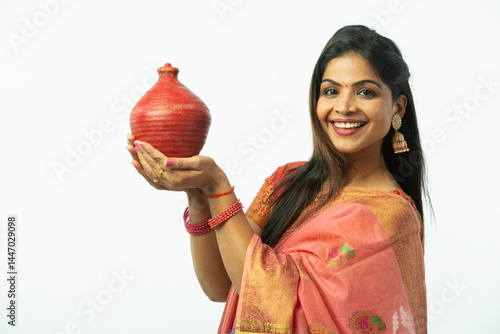 Photography Smiling Attractive Beautiful Indian Woman showing piggy bank wearing traditional colorful saree in festive celebration